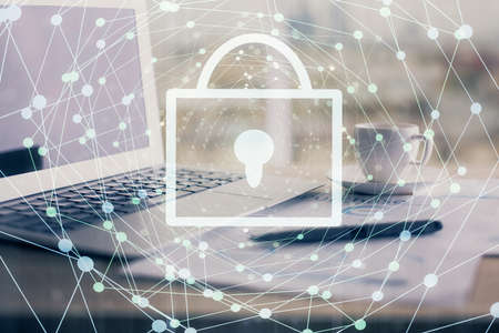 Double exposure of desktop with computer and lock icon hologram. Concept of data safety.