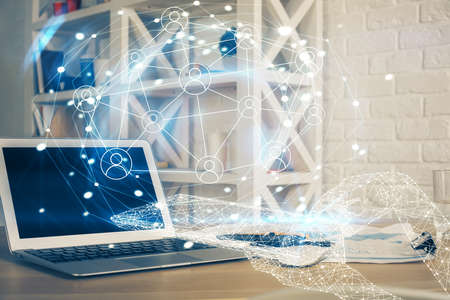Computer on desktop with social network hologram. Multi exposure. Concept of international people...