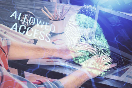 Fingerprint hologram with businessman working on computer on background. Security concept. Double exposure.の写真素材