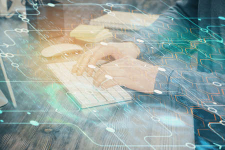 Double exposure of technology hologram with man working on computer background. Concept of big data.
