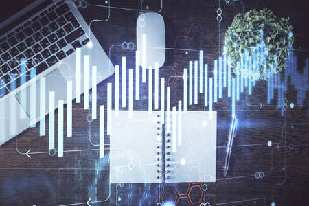 Stock market graph and top view computer on the table background. Double exposure. Concept of...