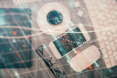 Multi exposure of forex graph hologram over desktop with phone. Top view. Mobile trade platform...