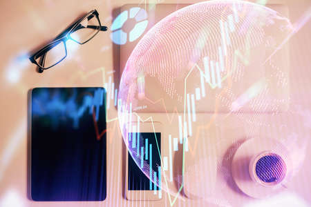 Multi exposure of financial chart hologram over desktop with phone. Top view. Mobile trade platform...