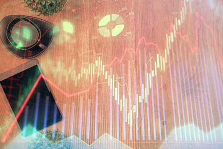Multi exposure of financial chart hologram over desktop with phone. Top view. Mobile trade platform concept.の写真素材