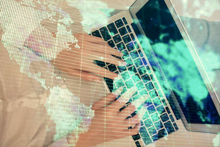 Double exposure of woman hands working on computer and financial theme hologram drawing. Top View....