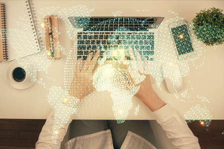 Double exposure of woman hands working on computer and financial theme hologram drawing. Top View....