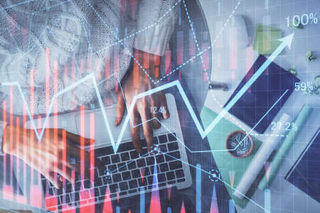 Multi exposure of woman hands working on computer and forex chart hologram drawing. Top View....
