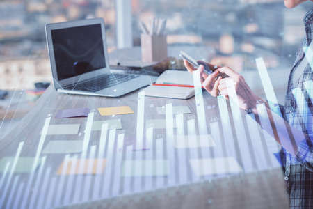 Double exposure of woman hands working on computer and forex graph hologram drawing. Financial...