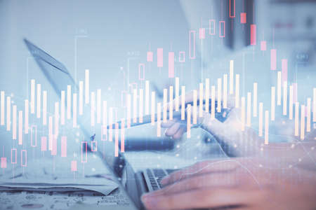 Multi exposure of woman hands typing on computer and financial graph hologram drawing. Stock market...