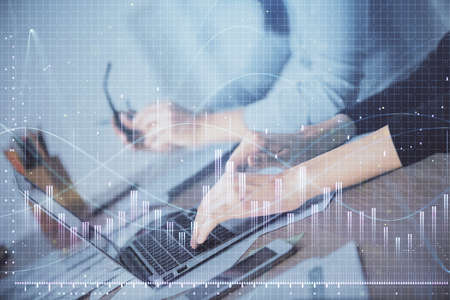 Multi exposure of woman hands typing on computer and financial chart hologram drawing. Stock market...