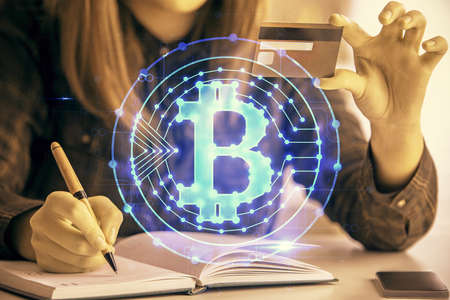 Multi exposure of woman on-line shopping holding a credit card and crypto theme drawing. Blockchain...