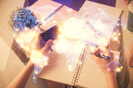 Multi exposure of woman on-line shopping holding a credit card and financial theme drawing. Business...