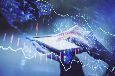 Double exposure of forex chart sketch hologram and woman holding and using a mobile device....