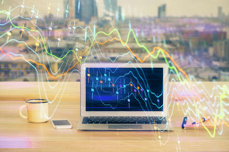 Double exposure of forex chart and work space with computer. Concept of international online...