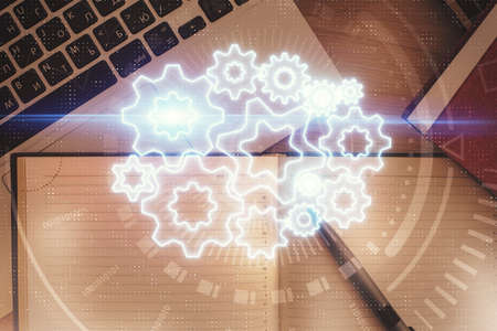 Business theme hologram drawings over computer on the desktop background. Top view. Multi exposure....