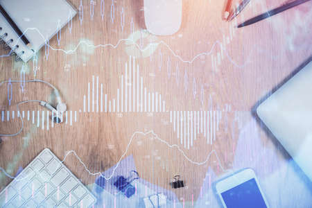 Multi exposure of forex graph hologram over desktop with phone. Top view. Mobile trade platform...