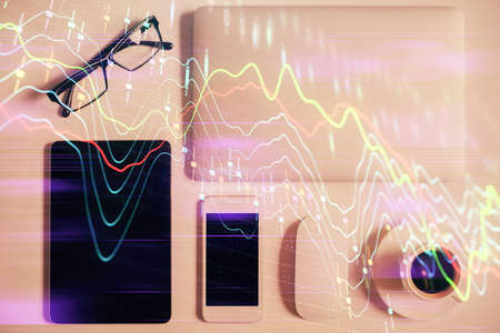 Multi exposure of financial chart hologram over desktop with phone. Top view. Mobile trade platform...