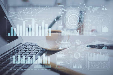 Double exposure of financial chart drawing and desktop with coffee and items on table background. Concept of forex market tradingの写真素材