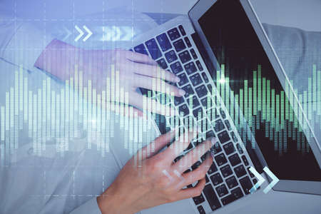 Double exposure of woman hands working on computer and forex chart hologram drawing. Top View....