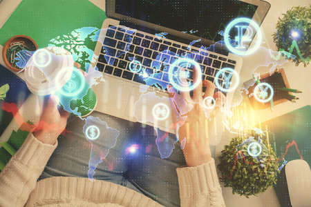 Double exposure of woman hands working on computer and forex chart hologram drawing. Top View....