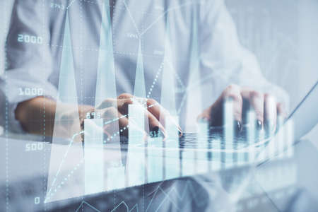 Double exposure of woman hands typing on computer and forex chart hologram drawing. Stock market...