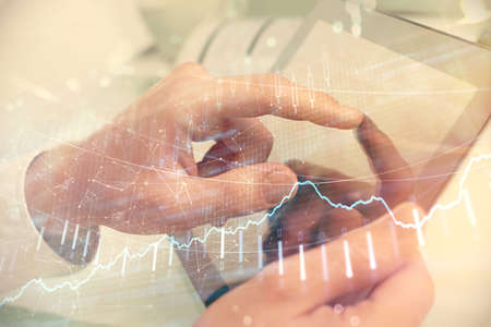 Multi exposure of mans hands holding and using a phone and financial chart drawing. Market analysis...