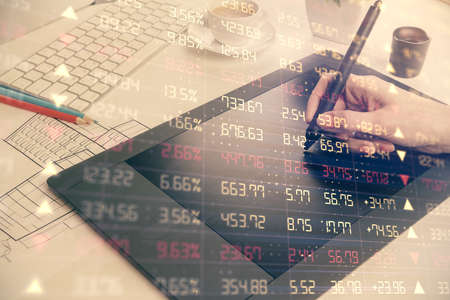 Double exposure of financial graph sketch hologram and woman holding and using a mobile device....