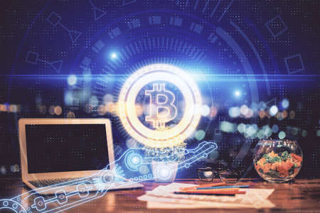Double exposure of blockchain and crypto economy theme hologram and table with computer background....