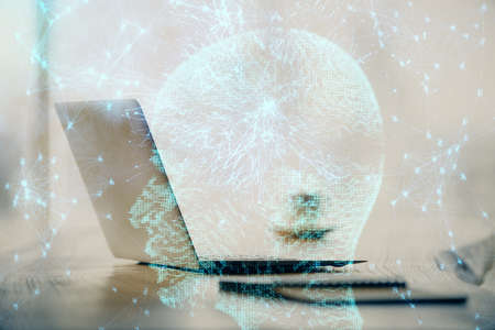 Double exposure of desktop with computer and brain drawing hologram. Artificial intelligence concept.の写真素材
