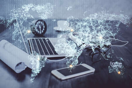 Computer on desktop with social network hologram. Double exposure. Concept of international people connections.の写真素材