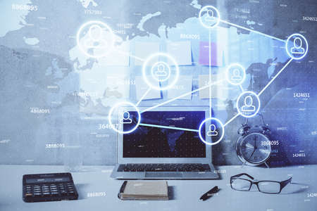 Computer on desktop with social network hologram. Double exposure. Concept of international people...