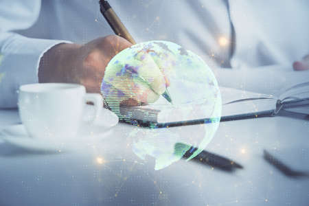 Man's hands working with notes background. Social networking scheme . Mixed media. Global business....