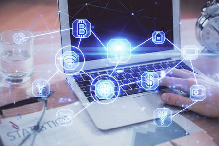 Social network theme hologram with businessman working on computer on background. Concept of world...
