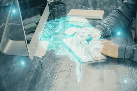 Man typing on keyboard background with brain hologram. Concept of big Data. Double exposure.