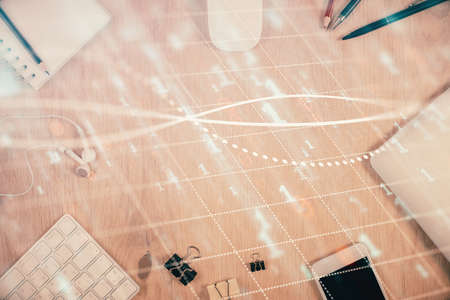 Multi exposure of forex graph hologram over desktop with phone. Top view. Mobile trade platform...