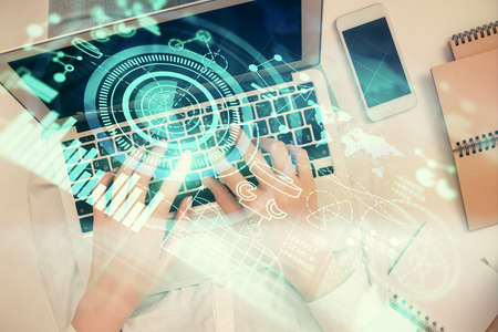 Double exposure of woman hands working on computer and financial theme hologram drawing. Top View....