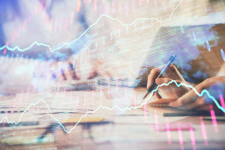 Multi exposure of woman hands typing on computer and forex chart hologram drawing. Stock market...