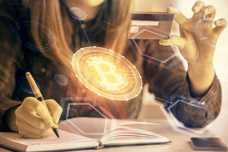 Multi exposure of woman on-line shopping holding a credit card and crypto theme drawing. Blockchain...