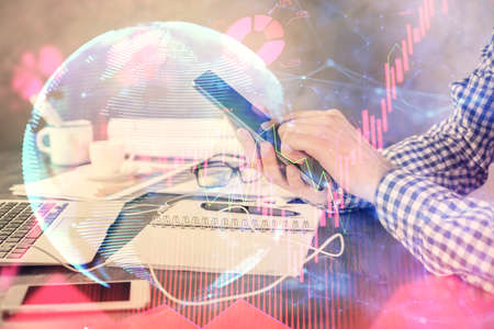 Double exposure of man's hands holding and using a phone and international business theme drawing.