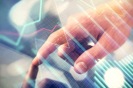 Multi exposure of man's hands holding and using a phone and financial chart drawing. Market analysis concept.の写真素材