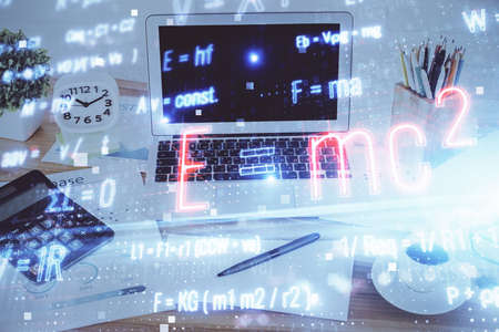 Desktop computer background and formula hologram writing. Double exposure. Education concept.