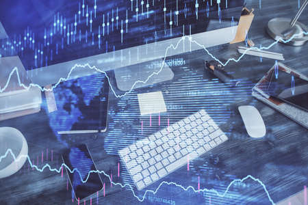 Double exposure of graph and financial info and work space with computer background. Concept of...