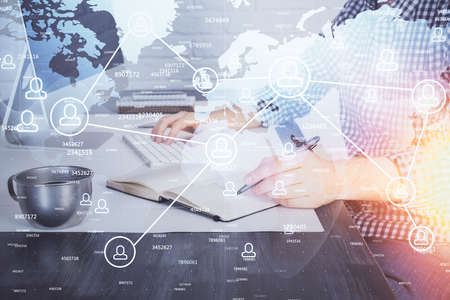 Social network theme hologram with businessman working on computer on background. Concept of world...