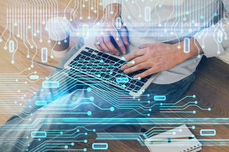 Multi exposure of data internet theme hologram with man working on computer on background. Concept...