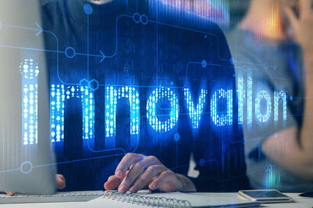 Multi exposure of data internet theme hologram with man working on computer on background. Concept of innovation.の写真素材