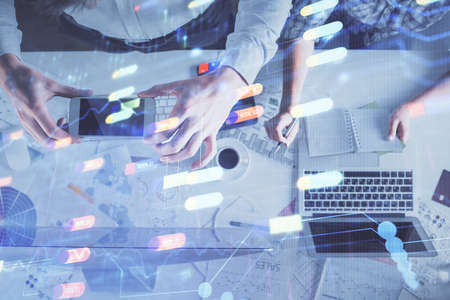 Double exposure of man and woman working together and data theme hologram drawing. Computer background. Top View.の写真素材
