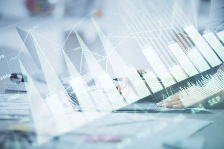 Double exposure of woman hands typing on computer and forex chart hologram drawing. Stock market...