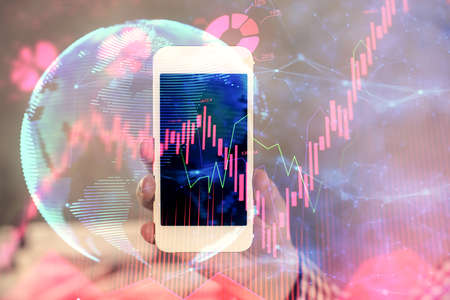 Double exposure of man's hands holding and using a phone and international business theme drawing.の写真素材