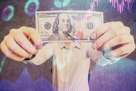 Multi exposure of forex graph drawing hologram and USA dollars bills and man hands. Technical Analysis concept.の写真素材