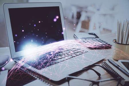 Computer on desktop with social network hologram. Double exposure. Concept of international people connections.の写真素材
